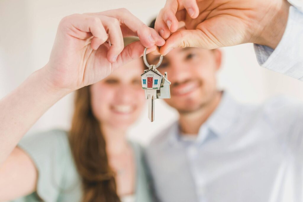 Couple holding keys to a home